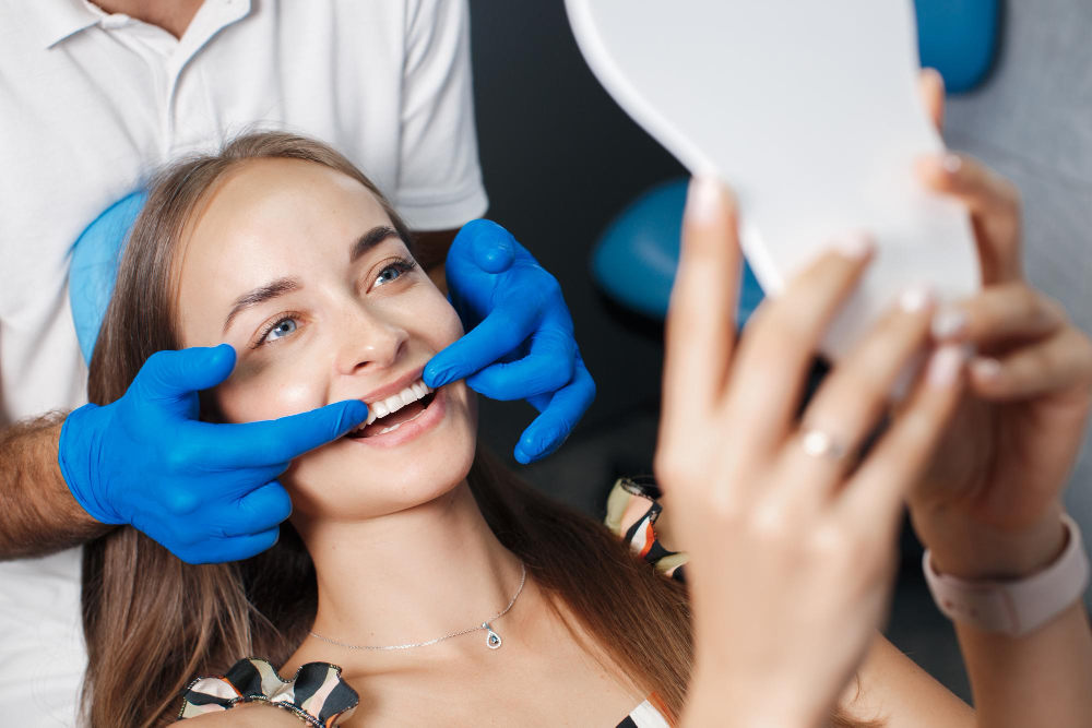 Dentist showing the patient the results of cosmetic dental treatment in Chandigarh.