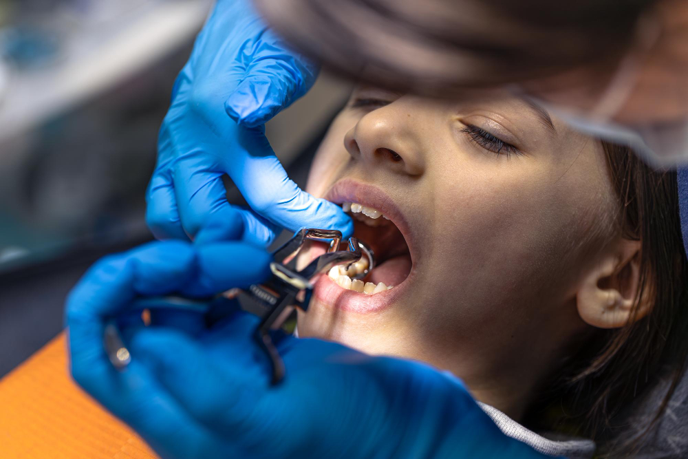 Child receiving a painless dental filling and tooth restoration treatment at RK Dental Practice.