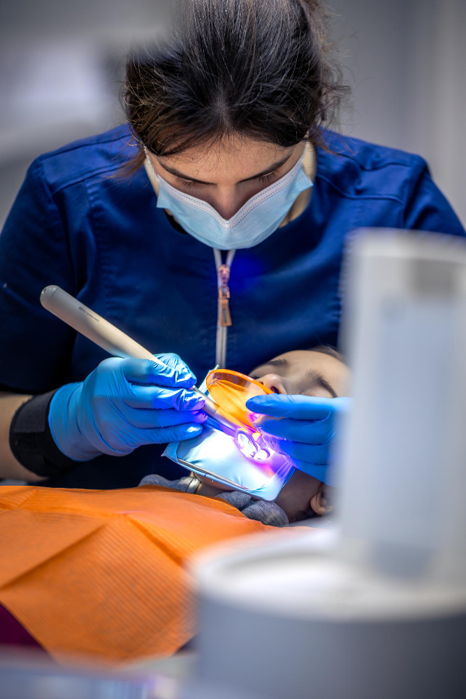 Tooth colored dental filling treatment using curing light at RK Dental Practice in Chandigarh.